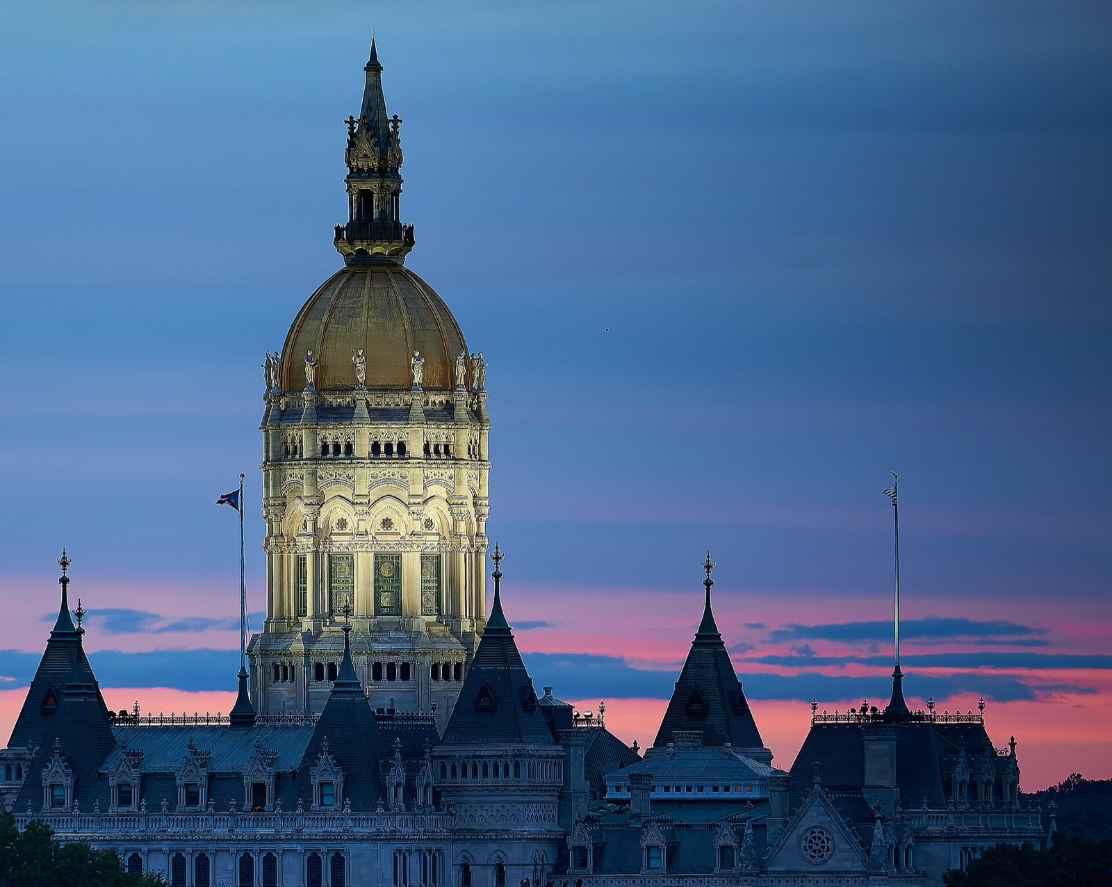 The gold dome of the Connecticut State Capitol in Hartford at sunset